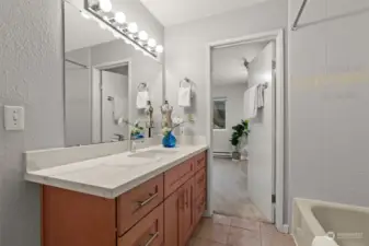 Spacious bathroom accessible from both the bedroom and hallway.
