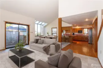 Virtually Staged - vaulted ceiling with 3 skylights & ceiling fan accents the family room