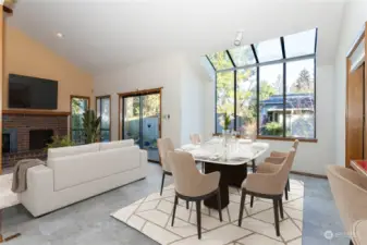 Virtually Staged = Window wall/ceiling provides lots of natural light, kitchen is adjacent to the right