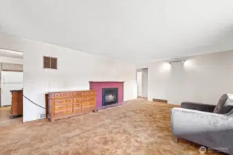 Good sized living room with wood fireplace