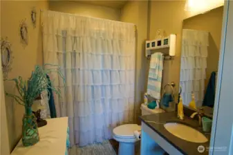 ADU bathroom with walk-in shower and built in seating inside.