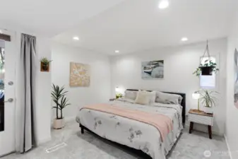 Ample space within the primary bedroom allows for large furniture items like a king-size bed.