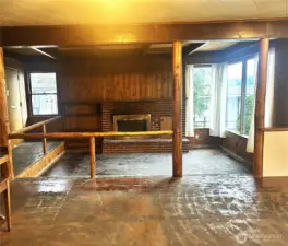 Cozy fireplace in sunken living room where many gatherings took place. The living room adjoins the spacious main floor lving area with dining, kitchen and multiple areas for music, games and just being together.