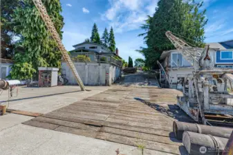 View from the water side of the dock toward the house with the west boat house and shop area under the house in view.