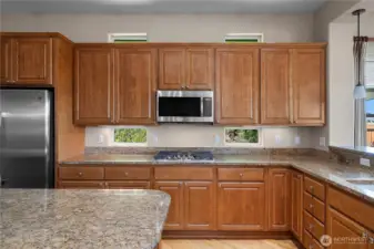 Stunning Kitchen with Granite Countertops, pullout shelves, Double oven, and stainless steel appliances.