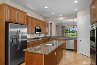 Stunning Kitchen with Granite Countertops, pullout shelves, Double oven, and stainless steel appliances.