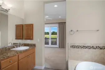 Large Primary bathroom featuring full tile shower, tub, double vanity and grantie countertops.