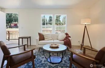 View of your living room looking back at your front door. Your kitchen is to your back. Notice how much yard is between you and the road.