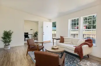 Another perspective of your living room and the front entry. The office/guest room is straight ahead through the opened double doors.