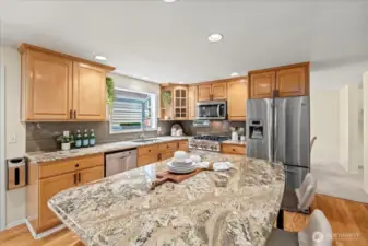 The beautiful kitchen features granite counters and an expansive island