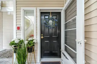 Welcoming entry with a screen door allows you to have a nice cross breeze on warm days.