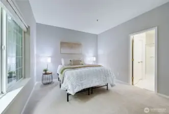 Enter the primary bedroom to explore how generously sized it is. Queen sized bed now, but a King would fit just fine. Lots of space for additional furnishings as well. Door to the right will lead us to the primary bathroom.