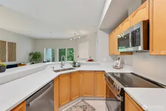 Your beautiful kitchen has a double level set-up that is extra wonderful when entertaining. It keeps the dirty dishes out of sight! The countertop has a nice bar overhang with seating for at least two. Notice all the outlets?      If you're a baker those outlets come in very handy.