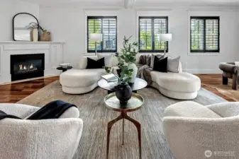 Expansive Great Room features a gas burning fireplace, walls of windows and French Doors leading to a private deck.