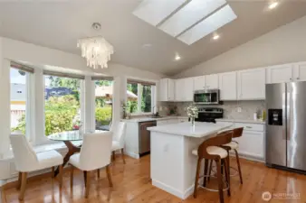The updated kitchen with bright quartz countertops, stainless appliances, and tons of natural light.
