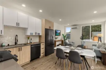 Sunlight streams across rich engineered hardwoods, accentuating clean architectural details and a palette that balances urban energy with natural warmth.