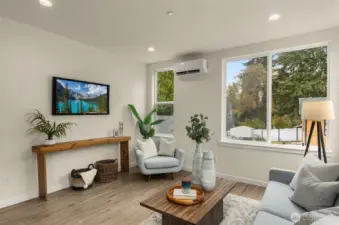 Expansive windows frame leafy neighborhood views, filling the space with golden light and highlighting the home’s timeless design.