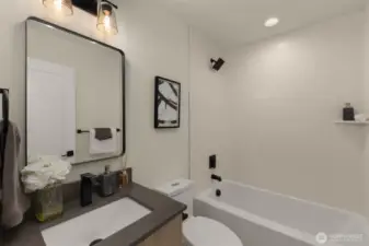 Polished mirrors, refined hardware, and rich cabinetry come together in this beautifully composed bathroom.