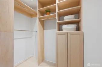 Lovely walk-in closet with custom organizers maximizing space.