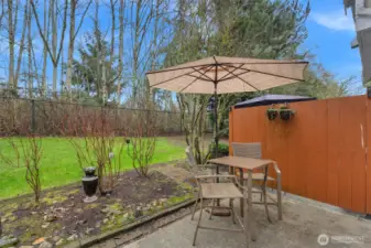 Private patio backing to greenery, a peaceful outdoor extension of your living space, perfect for relaxing or casual entertaining.