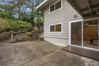 Sliding door opens to a private side patio—an extension of the main-level family room for seamless indoor-outdoor living.