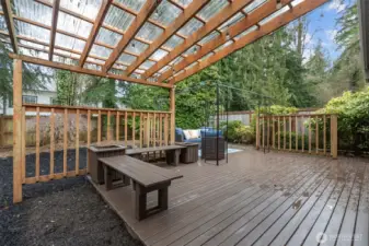 Spacious entertaining deck with covered pergola and string lighting—perfect for year-round outdoor gatherings.