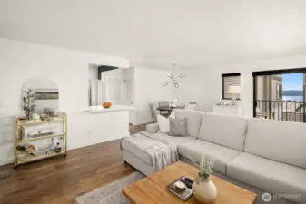 Light and bright! View towards the open kitchen bar, dining area and slider to the deck.