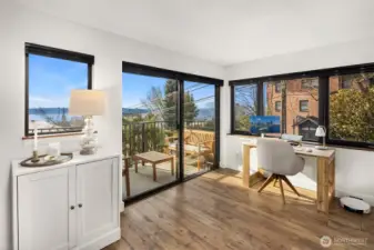 Wonderful natural light- A great spot to work from home!  Note cabinet to left of slider- it houses an A/C unit- hiding while not in use. All of these windows have custom Hunter Douglas Duolite top-down- bottom up shades with light filtering and blackout options!