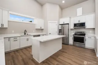 Big island, high-end Kitchen Aid stainless steel appliances, & walk-in pantry.