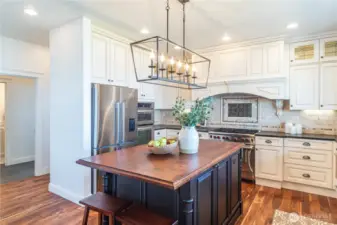 The kitchen island offers a place to gather, cook together, and enjoy peace and tranquility at 15 White Rock Lane.