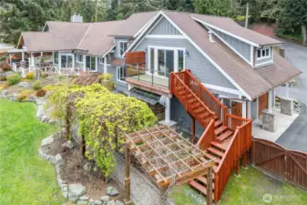 15 White Rock Lane has 4 bedrooms, including one in the attached apartment, complete with a full kitchen and private access via the exterior stairway in this photo. Arbors, flower & vegetable gardens and more await you.