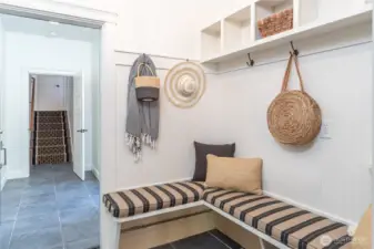 A few steps down from the kithcn is this short walk way, a guest bedroom is to the left, and this mud room connects to the garage behind the photo.  See the 3d videos for more!