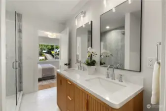 Stunning primary bathroom with dual vanity, huge walk-in shower and designer tile throughout.
