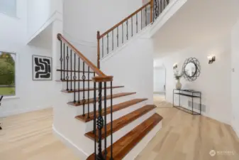 Hardwood staircase leading to upstairs sleeping quarters