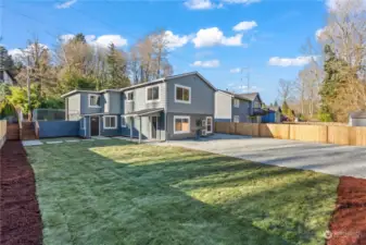 Lower Floor with Entries for Units B (2-Bedroom, Left) and C (1-Bedroom, Right), plus plenty of Parking Space and Play Space!! New Cedar Fencing, too!