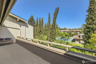 Unwind and gaze at endless skyline views from the vast private deck overlooking lush grounds, the pool, and the tennis court.