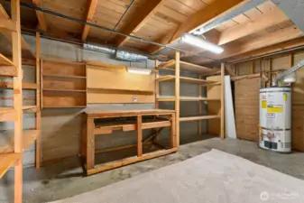 Utility/storage room with tons of shelves and work bench