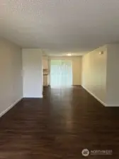 View from living room to dining and slider to backyard.