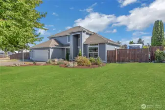 RV parking on right of home. Grass is enhanced