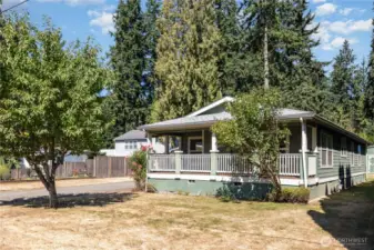 Home offers a serene green color palette that blends in perfectly with the surrounding trees.