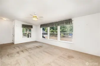 The living room boasts vaulted ceilings and large windows, creating a bright and airy feel.