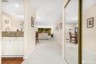 Entry corridor showcasing mirrored closet doors and continuous natural light.