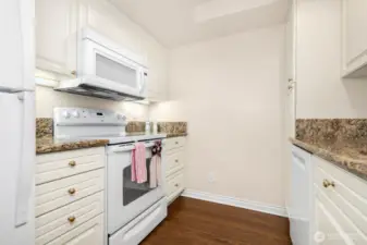 Matching white appliance suite enhances the bright, cohesive kitchen design.