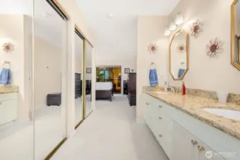 Primary suite entry with dual mirrored closets leading to an updated bath.