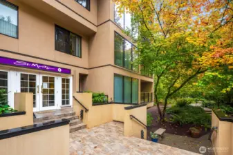 Front entry with tiled terrace and seating area welcoming residents and guests.