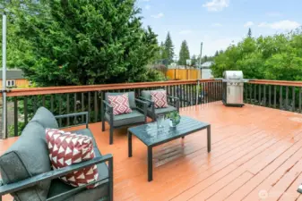 Just outside - an awesome deck perfect for outdoor entertaining or eating al fresco. Barbecue is in great shape and can stay with the house!