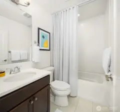 Second bedroom's full bath with custom seersucker curtain