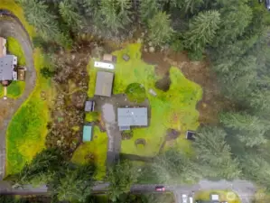 2.49 Acres featuring detached garage, RV Parking, outbuildings, and a firepit.