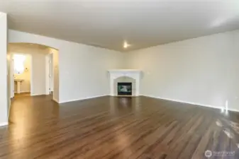 Informal Living Room Leads Right to Downstairs Half Bath and Office/Den