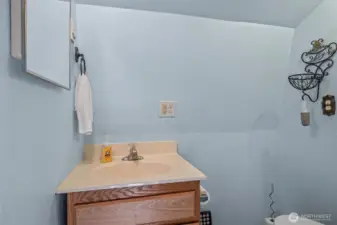 Half bath upstairs with sink and toilet.